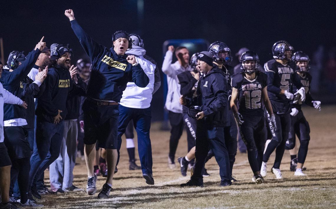 Kuna head football coach Sherman Blaser celebrates a fourth-quarter interception during the 4A state football semifinals game Friday at Kuna High School.