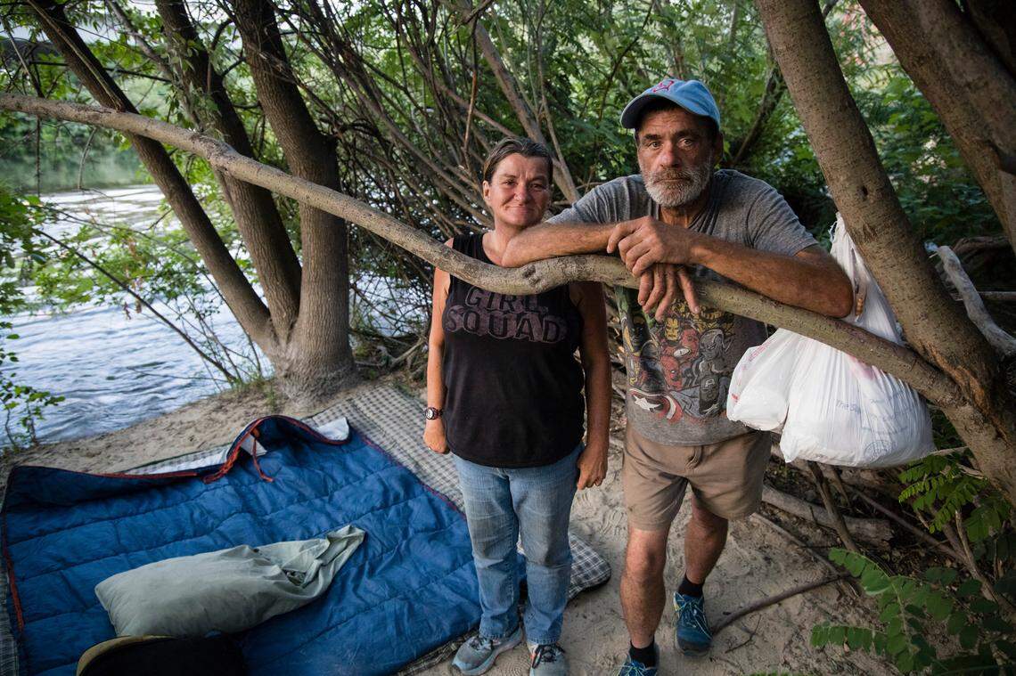 Susan Pappas and Mark Hennessy pose for a portrait in the spot where they planned to spend the night on Aug. 28.