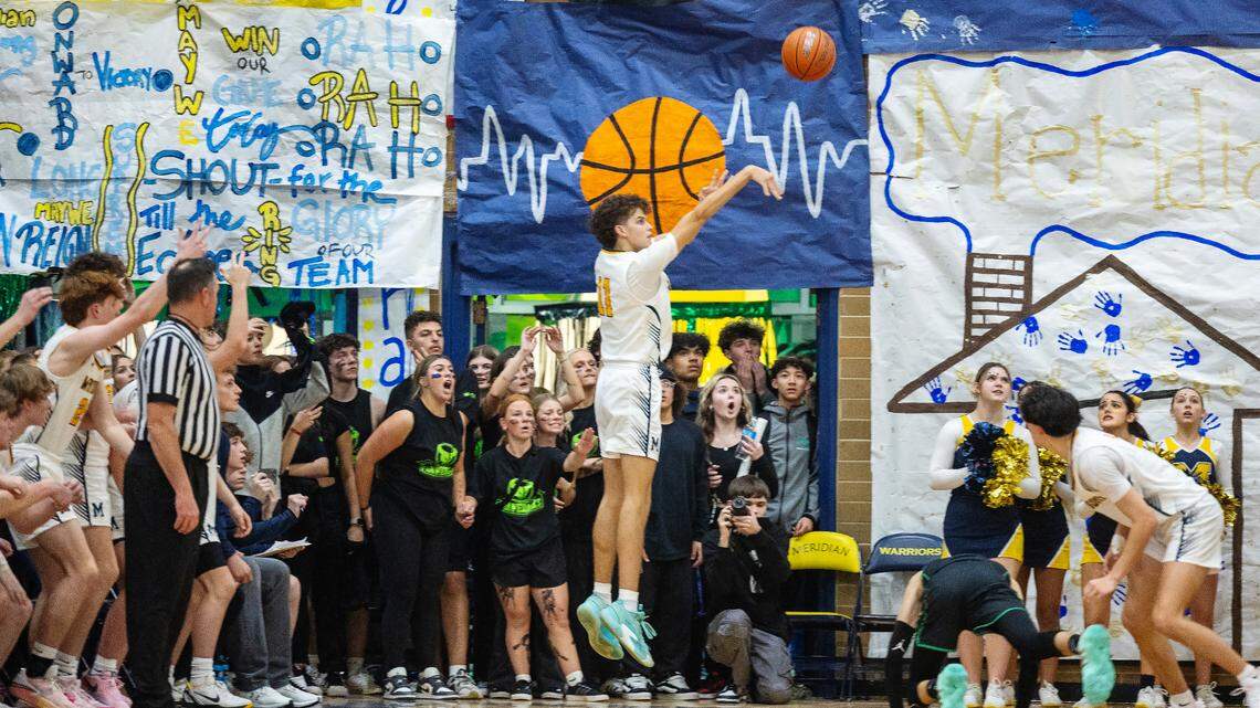 Meridian senior T.J. Sanor drains a 3-pointer last season during a rivalry game against Mountain View.