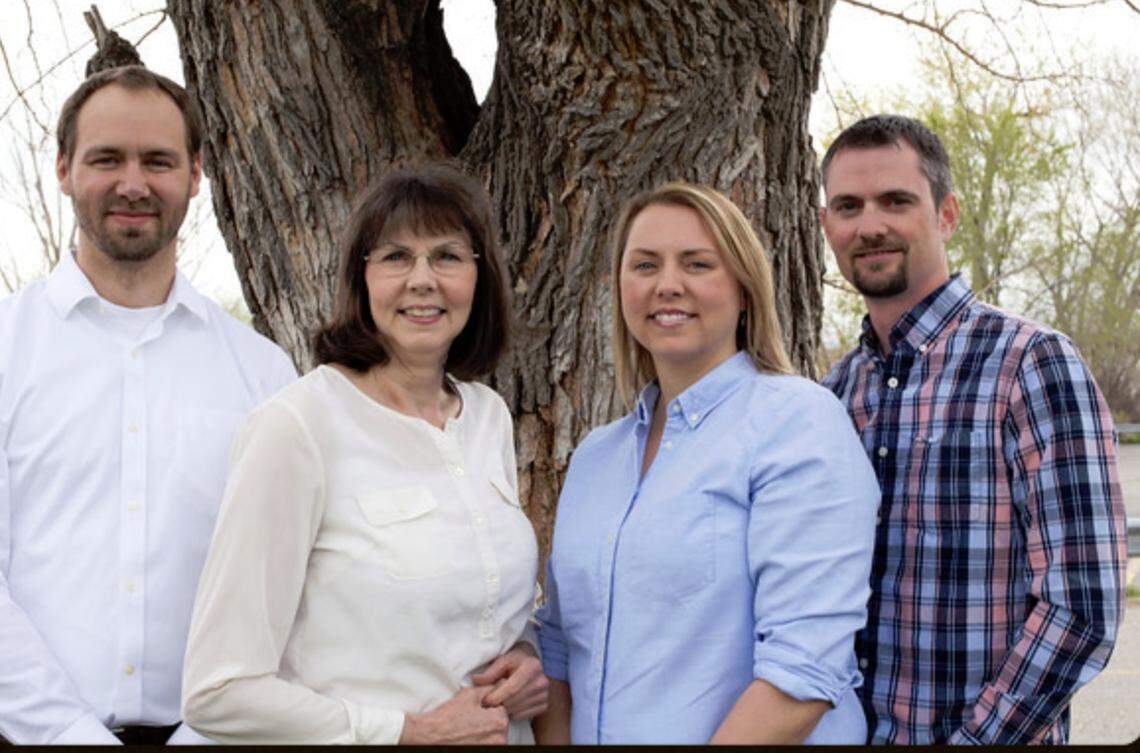 Laura Sandidge, second from left, pictured with her family and co-owners of Advocates for Inclusion, on the AFI site.