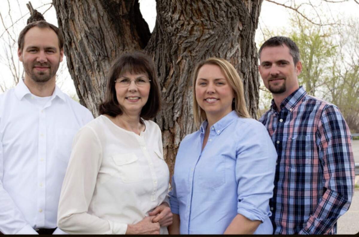 Laura Sandidge, second from left, pictured with her family and co-owners of Advocates for Inclusion, on the AFI site.