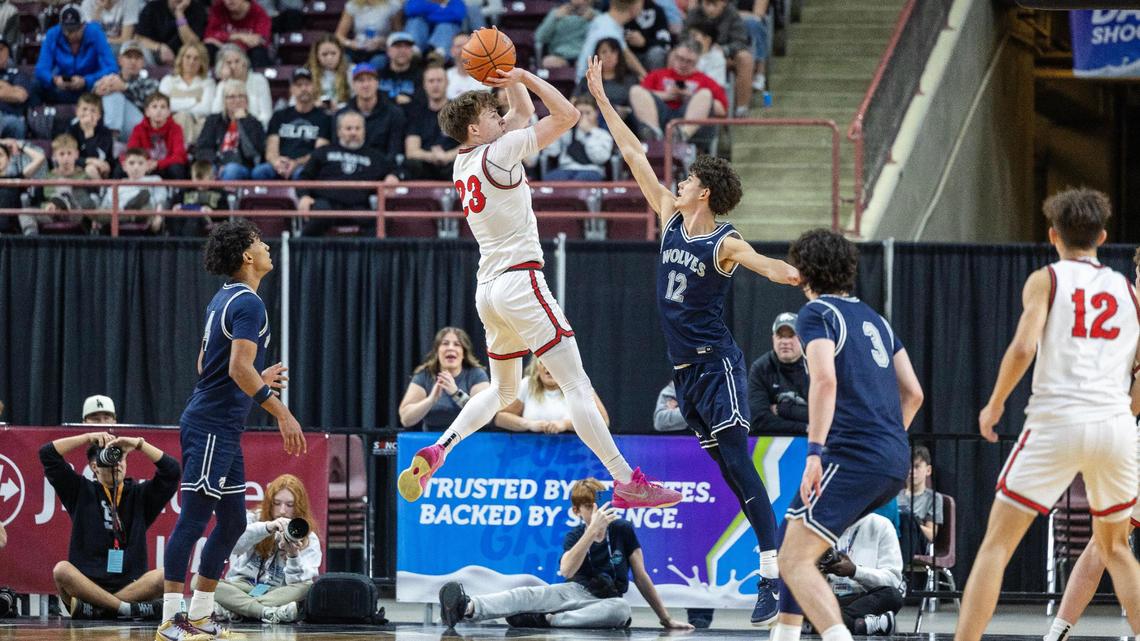Owyhee’s Boden Howell shoots over Lake City’s Carter Kloos to score in the second half of the championship game of the 6A boys basketball state tournament held at Ford Idaho Center in Nampa in March. Owyhee defeated Lake City 77-46.