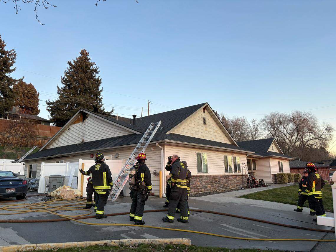 Boise fire crews stand outside the damaged Ashley Manor building.