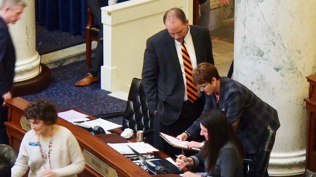 Rep. Melissa Wintrow, D-Boise, huddles with other members of the Idaho House of Representatives after a vote on her bill to restrict gun rights for certain sex offenders was delayed Wednesday. Her bill narrowly passed Thursday, but only after offering a compromise bill.