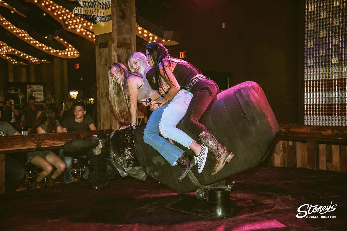 Bargoers ride a mechanical bull at Stoney’s in Las Vegas. There will be one in Emmett, too.