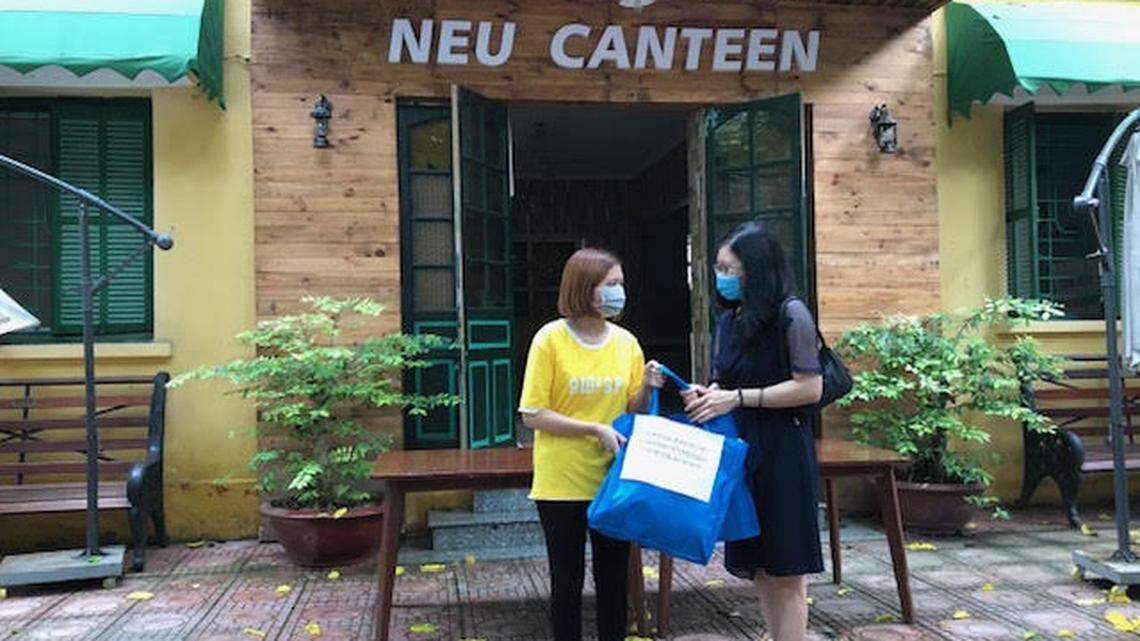 Phan Thi Thuc Anh, right, a 1995 graduate of Boise State University and vice dean of the International School of Management and Economics at Vietnam’s National Economics University, hands bags of food to a student amid a COVID-19 lockdown that kept students in Hanoi and unable to go home for family support.