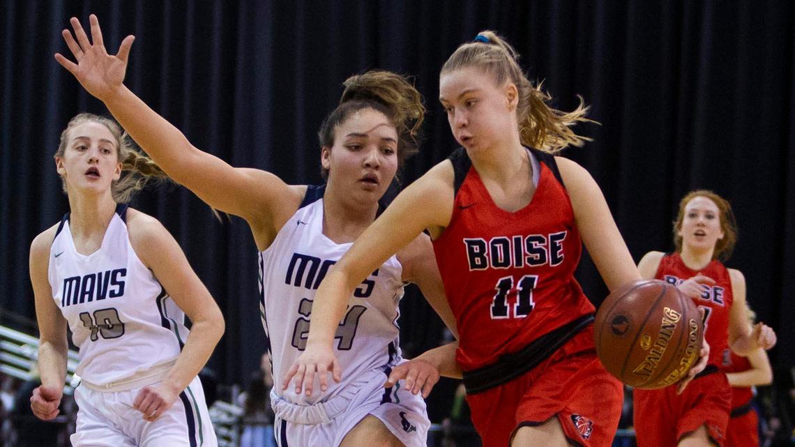 Boise’s Ava Oakland drives past Mountain View’s Trinity Slocum during the first round of the 5A girls basketball state tournament in February.
