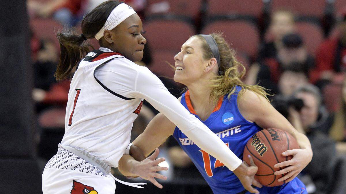 Boise State guard Braydey Hodgins protects the ball from Louisville guard Dana Evans during a first-round NCAA Tournament game March 26, 2018, in Louisville, Ky.