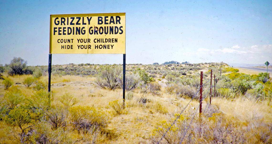 Motorists traveling near Beachs Corner, an unincorporated area 5 miles northeast of Idaho Falls, were warned to keep an eye out for grizzly bears in this roadside sign from Stinker. The sign is one of two still in existence. Beachs Corner is the junction of U.S. 26 and Idaho 43.