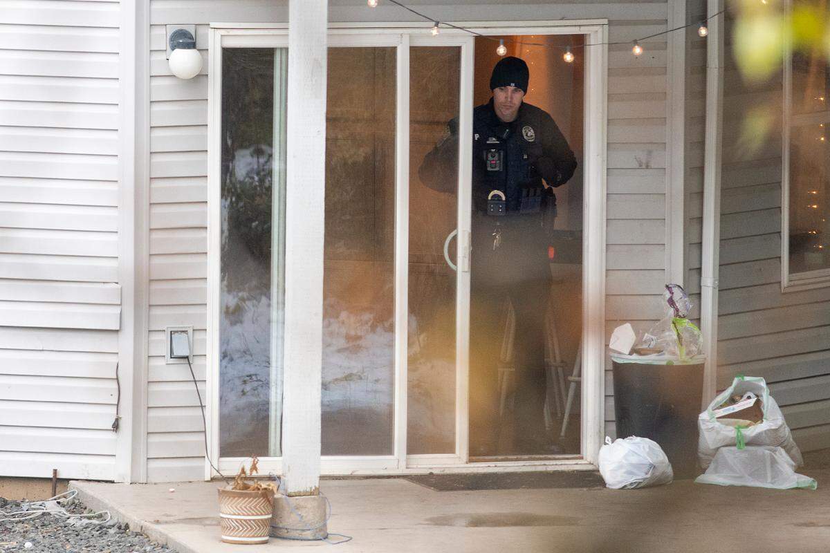 Police officers investigate the quadruple homicide at an off-campus house on King Road in Moscow near the University of Idaho.