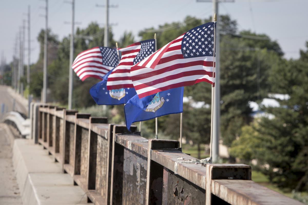 Flags atop the Cloverdale Road overpass commemorate the victims of the fiery June 16 crash that killed four people on Interstate 84 below. The crash killed three airmen stationed at Mountain Home Air Force Base and a commercial-truck driver from New York state.