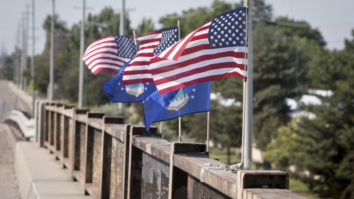 Flags atop the Cloverdale Road overpass commemorated victims of a fiery June 16 crash that killed four people on Interstate 84 below. A bunch of the nearly three dozen flags on the overpass were recently vandalized.
