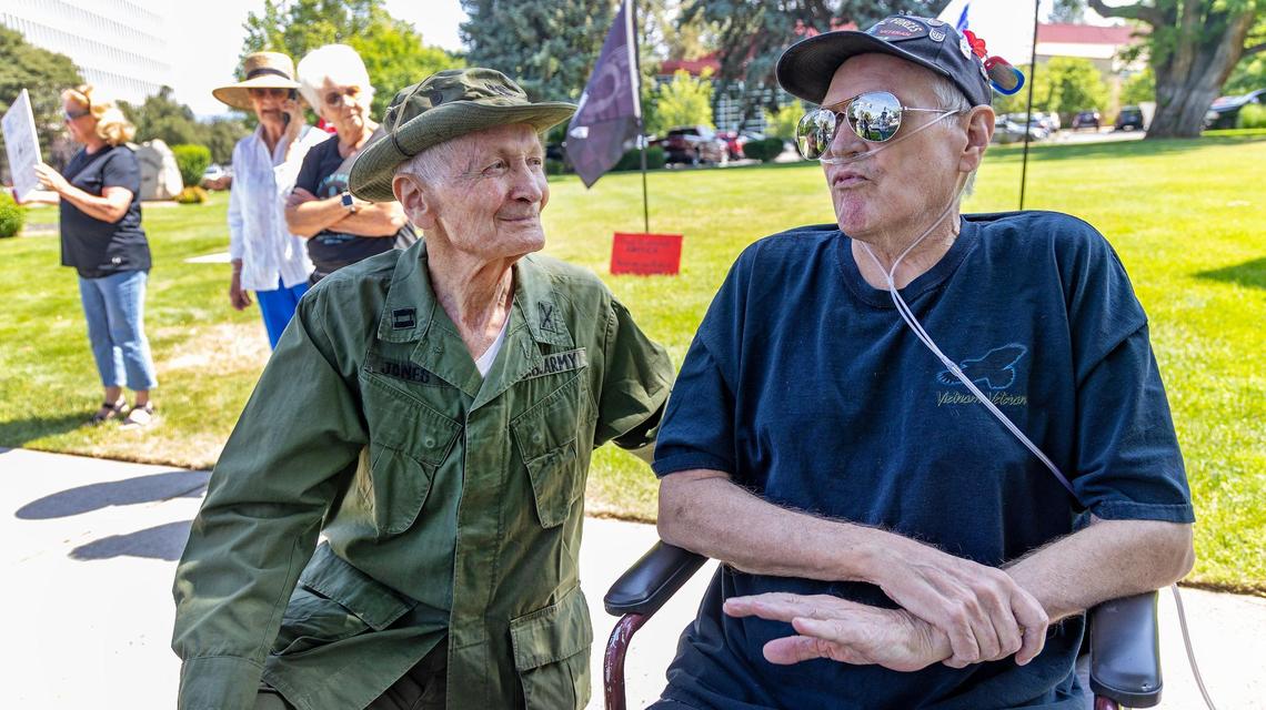 Army veterans Jim Jones, left, and James Peterson, right, talk about the issues facing veterans and VA employees due to funding cuts by the Trump administration during a protest outside of the Boise Veterans Affairs Medical Center during a protest, Friday, June 6, 2025.