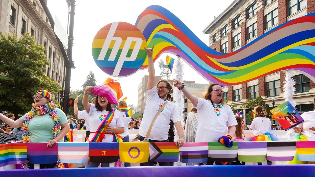 People wave from a HP Inc. float during the parade for Boise Pride Festival on Sunday, Sept, 11, 2022. The Fred Meyer Pride Parade circled through downtown Boise with nearly 70 entries ranging from small organizations walking the route to corporate floats.