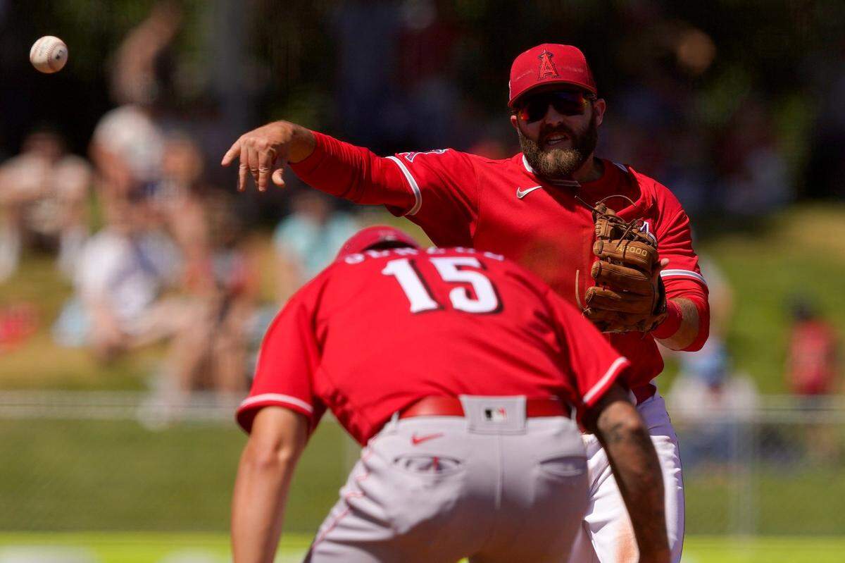 Cincinnati Reds’ Nick Senzel is forced out by Los Angeles Angels’ Michael Stefanic, facing, as he turns a double play during the third inning of a spring training game April 1 in Tempe, Arizona.