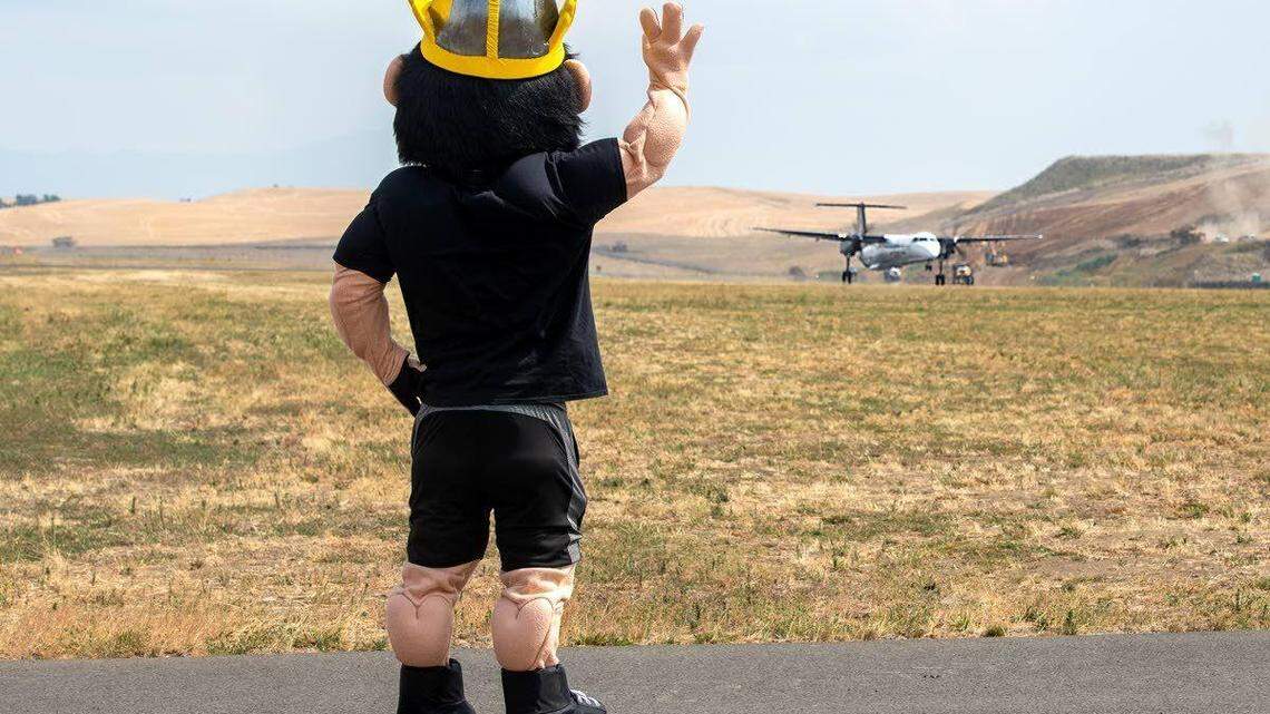 Joe Vandal, the University of Idaho’s mascot, waves goodbye to an Alaska Airlines nonstop flight to Boise from the runway at the Pullman-Moscow Regional Airport in Pullman, Washington. With Washington State University, the U of I subsidizes the flight for up to $500,000 annually.