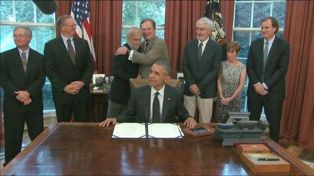 Mike Simpson and Rick Johnson hug after President Barack Obama signs the bill protecting the Boulder-White Clouds.