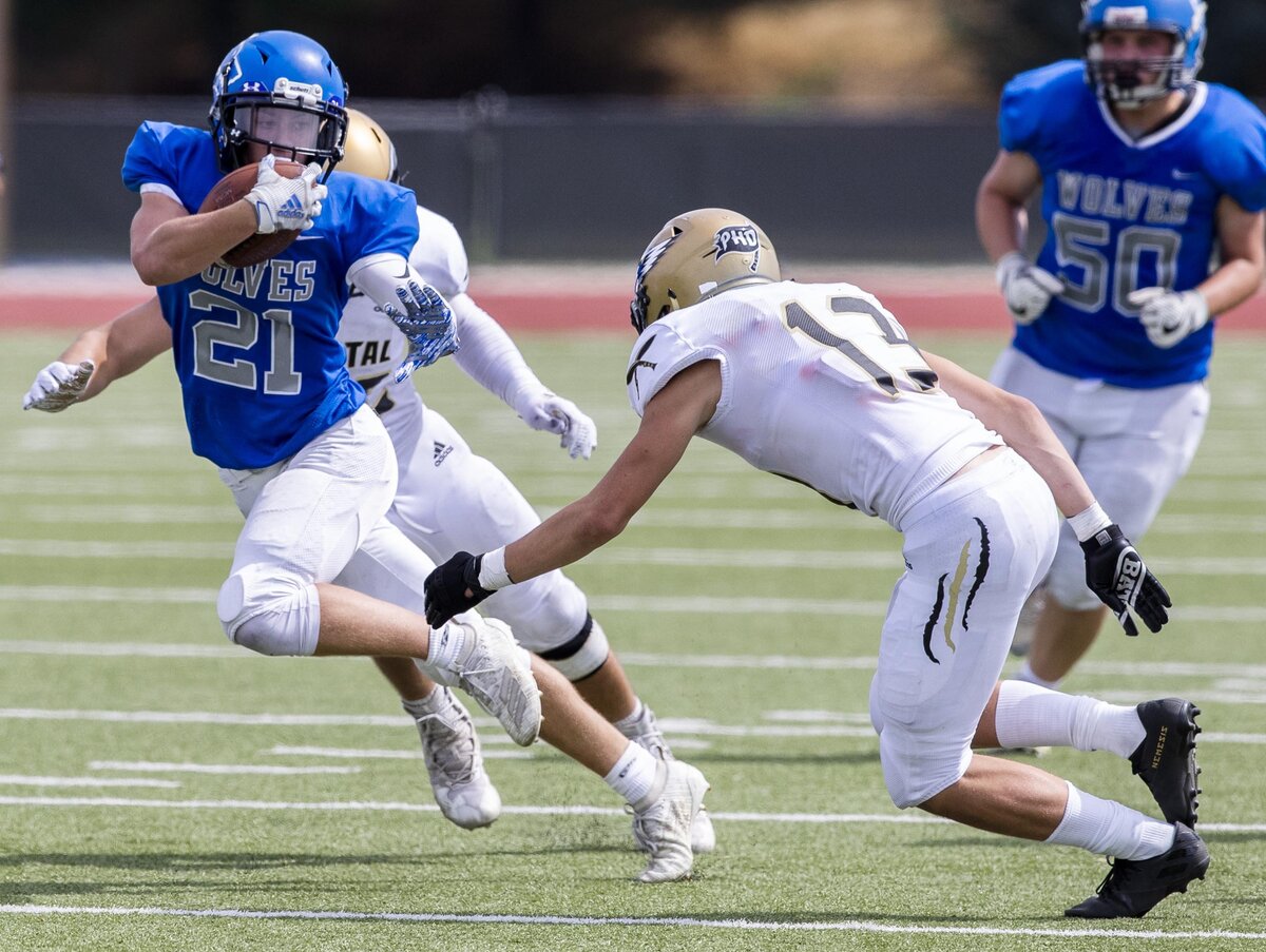 Timberline running back Taylor Marcum zigs and zags through Capital’s defense Sept. 7, at Dona Larsen Park in Boise.