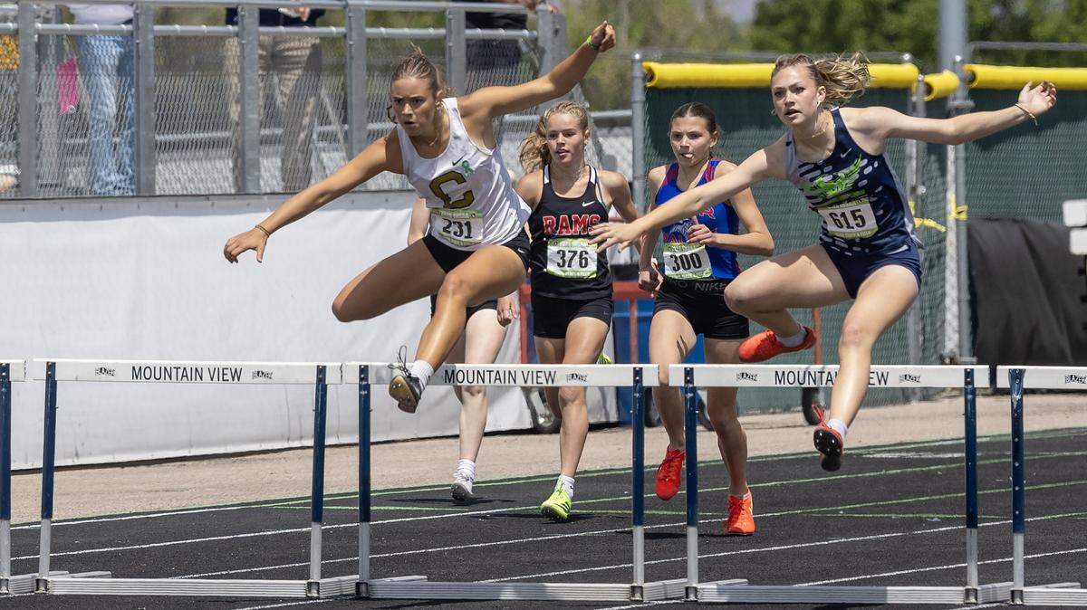 Capital's Alena Garrison, left, and Mountain View's Kara Beck, right, jump over hurdles in the 6A girls 300 meter hurdles at the IHSAA 6A/5A Track and Field Championships, Saturday, May 16, 2026 at Mountain View High School. Beck finished in first with Garrison in second.