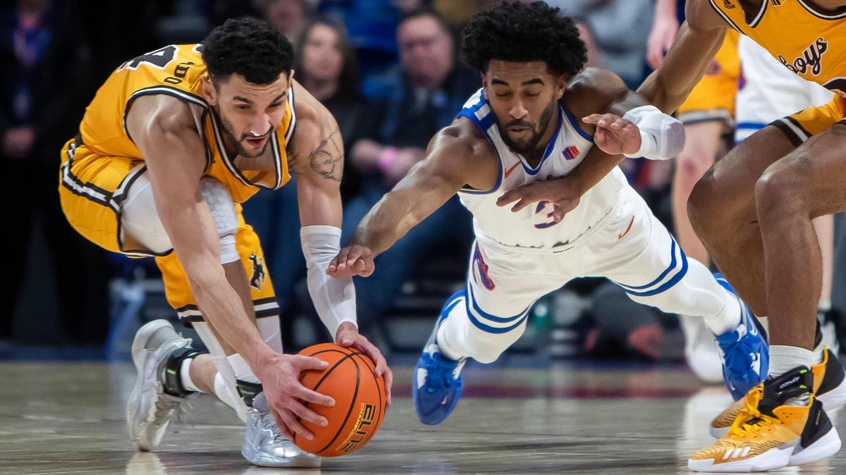 Boise State guard Kobe Young dives for a loose ball on defense, but the ball was recovered by Wyoming guard Hunter Maldonado in the first half Saturday at ExtraMile Arena in Boise.