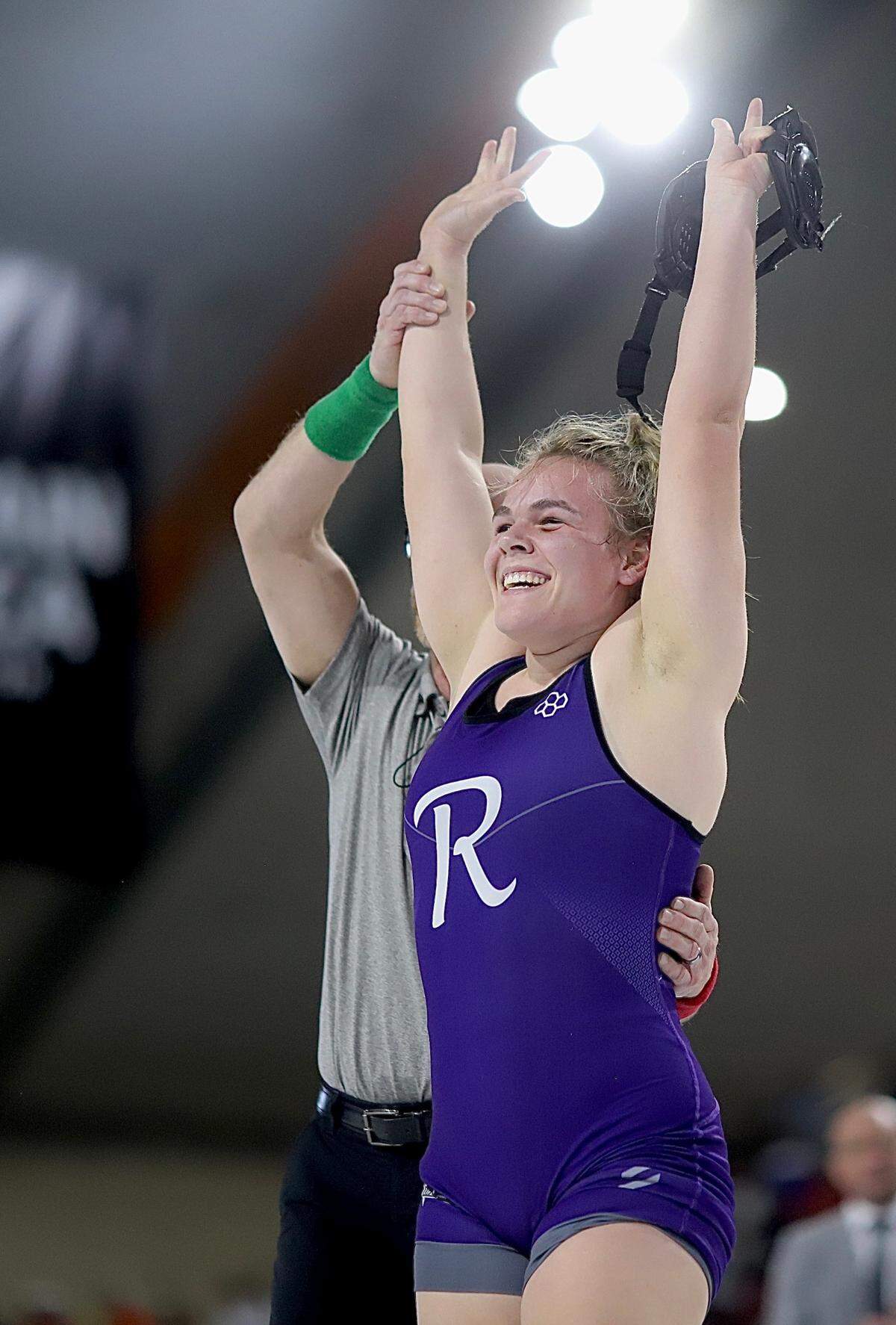 Rocky Mountain senior Gavin Brown raises her hand in victory Saturday after winning the girls 165-pound title Saturday in Pocatello, leading her team to the girls team title, as well.