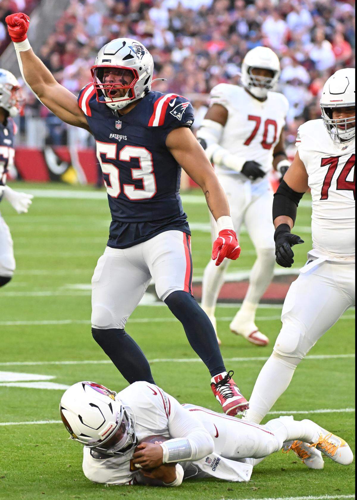 New England’s Christian Elliss celebrates a sack of Arizona quarterback Kyler Murray at State Farm Stadium in a 2024 game.