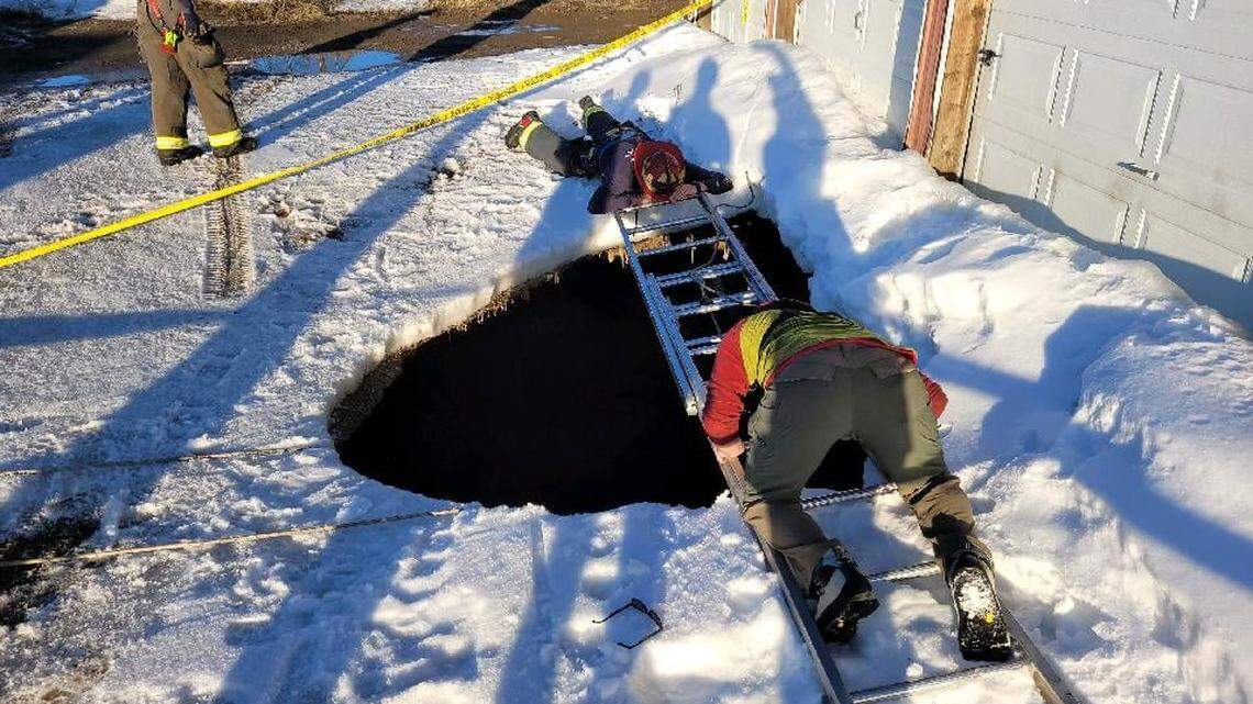 A freezing 30-foot-deep sinkhole opened beneath a Leadville, Colorado, mini-storage lot customer Thursday, requiring a daring rescue, firefighters say.