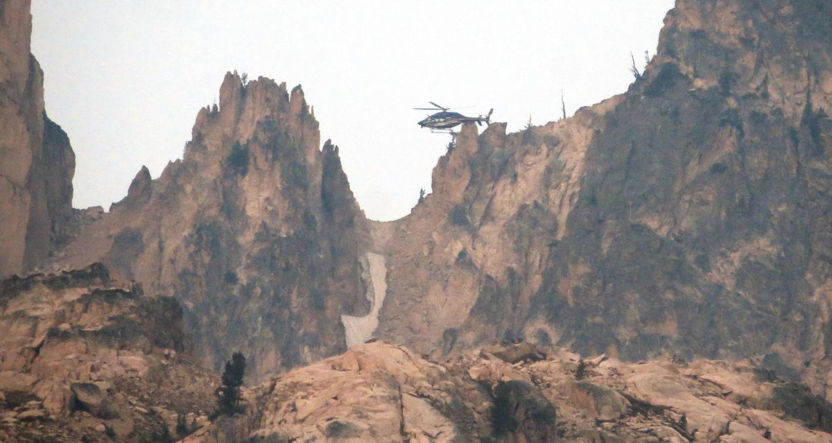 Campers at Baron Lake watched the Two Bear Air helicopter rescue of Dick Ross on Aug. 24. He was picked up from just below the notch on the left.
