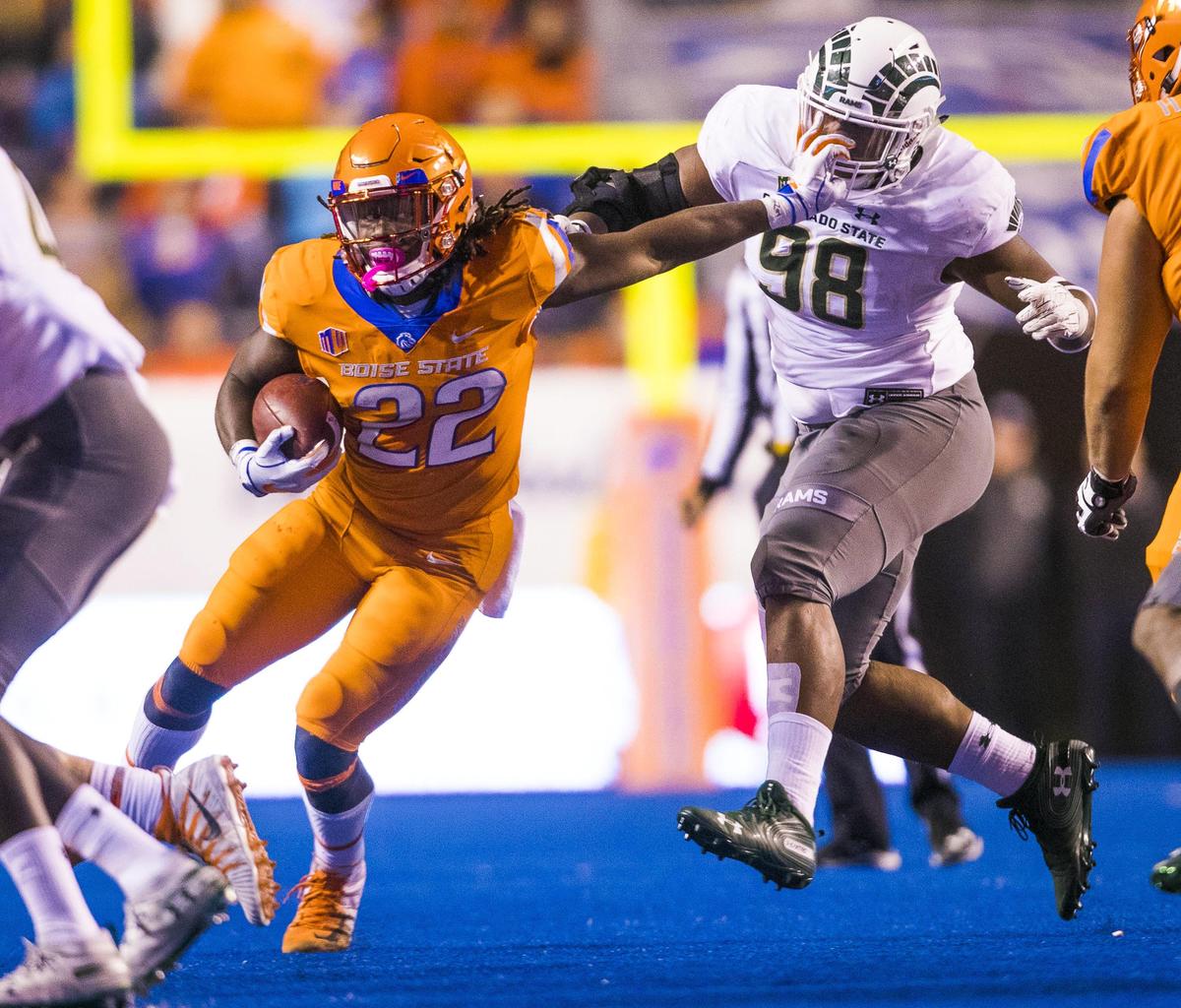 Boise State running back Alexander Mattison (22) staves off Colorado State defensive lineman Ellison Hubbard (98) on a run in the fourth quarter Friday, Oct. 19, 2018 at Albertsons Stadium in Boise.