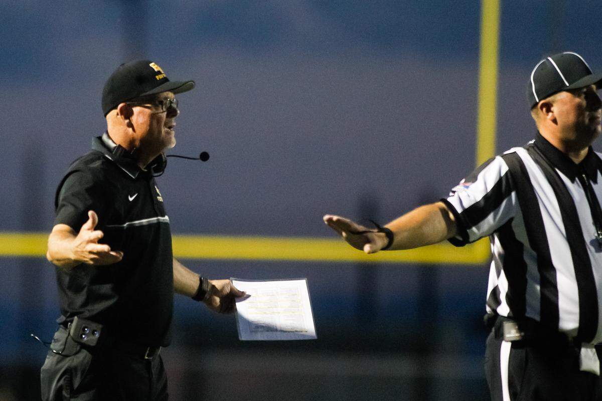 Bishop Kelly coach Tim Brennan works a sideline official during a 2016 game at Middleton.