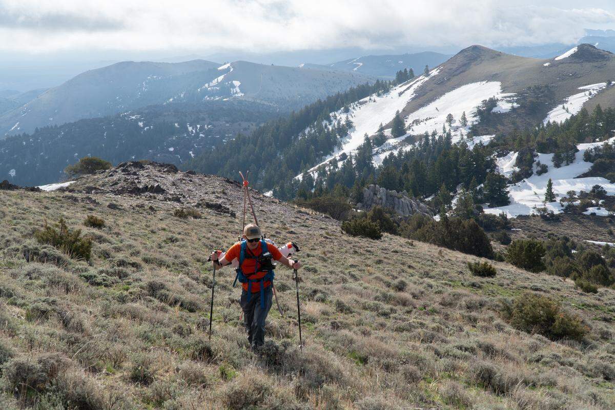 Robby Milo ascends the south face of Quicksilver Mountain in the Owyhees. Backcountry skiing in the spring sometimes means throwing your gear on your back before hiking bare ground to reach snowy slopes.