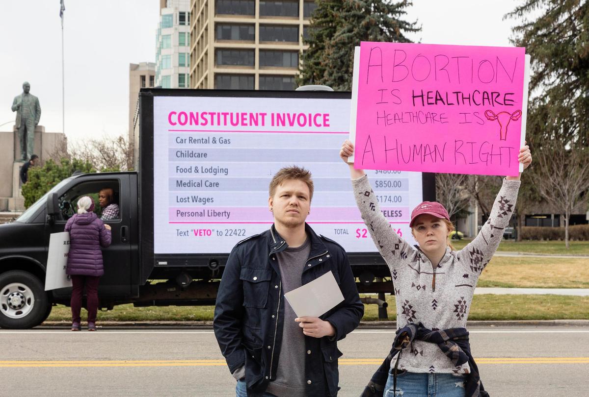 Blake Coker and Autumn Myers, both of Boise, protest Senate Bill 1309 during a rally at the Idaho Capitol on March, 19, 2022. The law would ban abortion after around 6 weeks and uses a civilian enforcement mechanism in an effort to circumvent legal challenges.