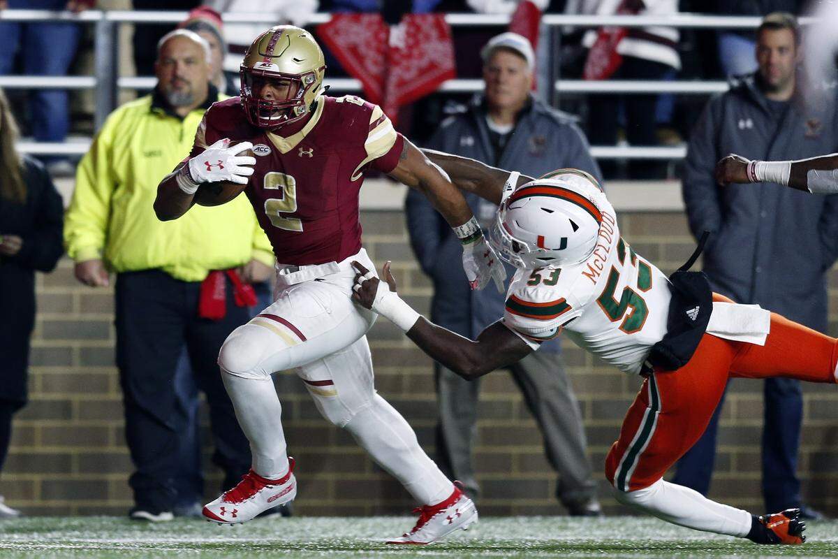Boston College running back AJ Dillon (2) breaks a tackle by Miami linebacker Zach McCloud (53) on a touchdown run during the second half Oct. 26 in Boston.