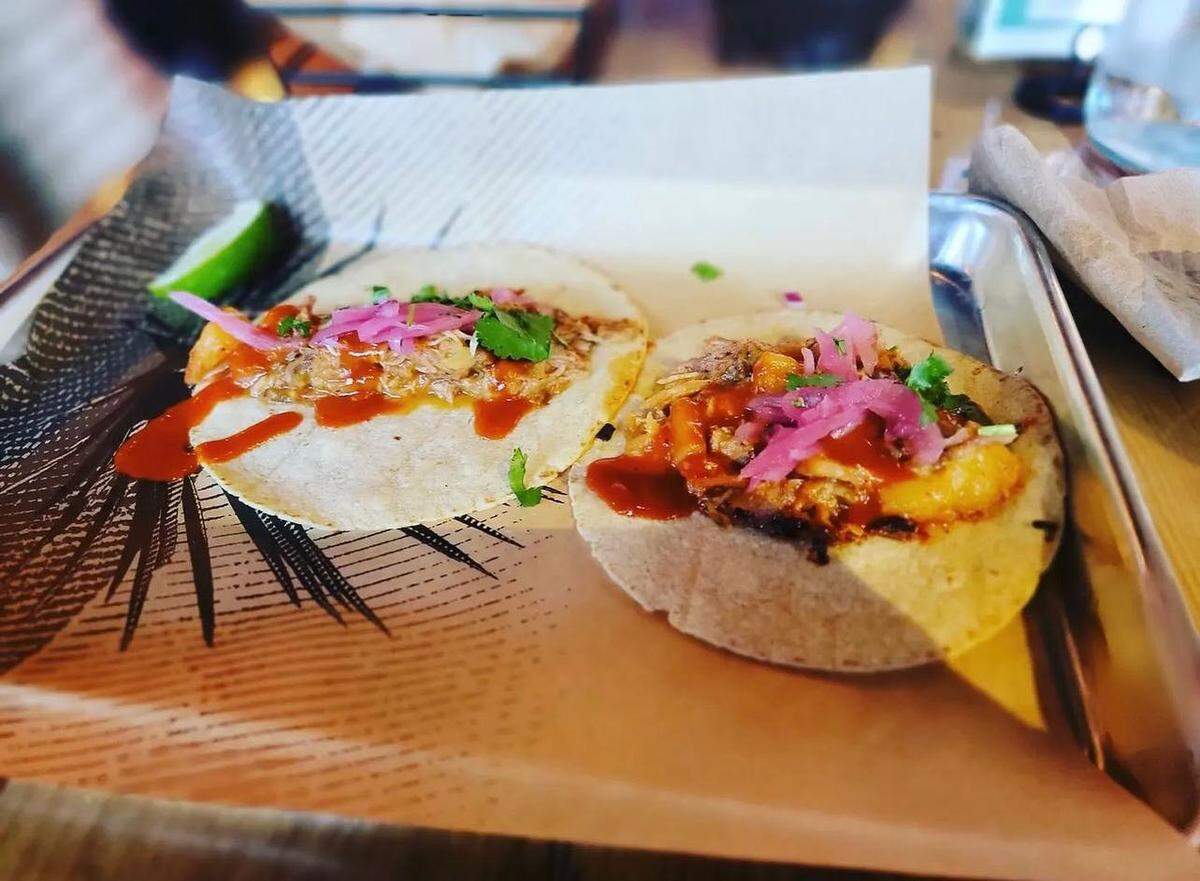 Pork Al Pastor tacos ($11): tender pork, grilled pineapple, pickled red onion and cilantro.