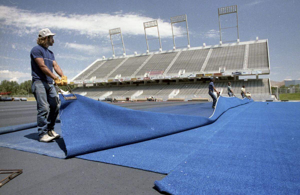 Crews install blue turf at Bronco Stadium in Boise, July, 18, 1986.