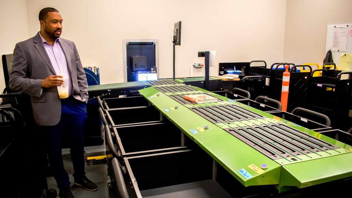 Meridian Library District Director Nick Grove shows the machine that sorts books at the district’s new Pinnacle branch.