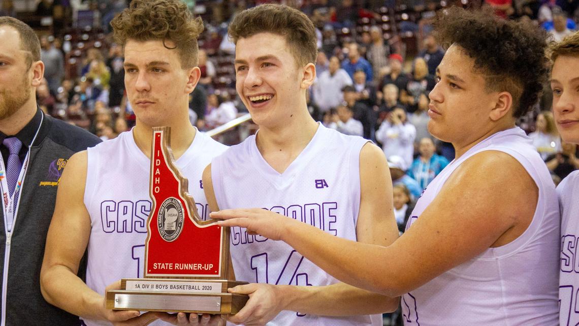 Cascade seniors Michael Onaindia, Jacek Jensen and Cruz Duerden pose for photos with the second-place trophy. Cascade lost 74-57 to undefeated Lakeside on Saturday at the Ford Idaho Center.