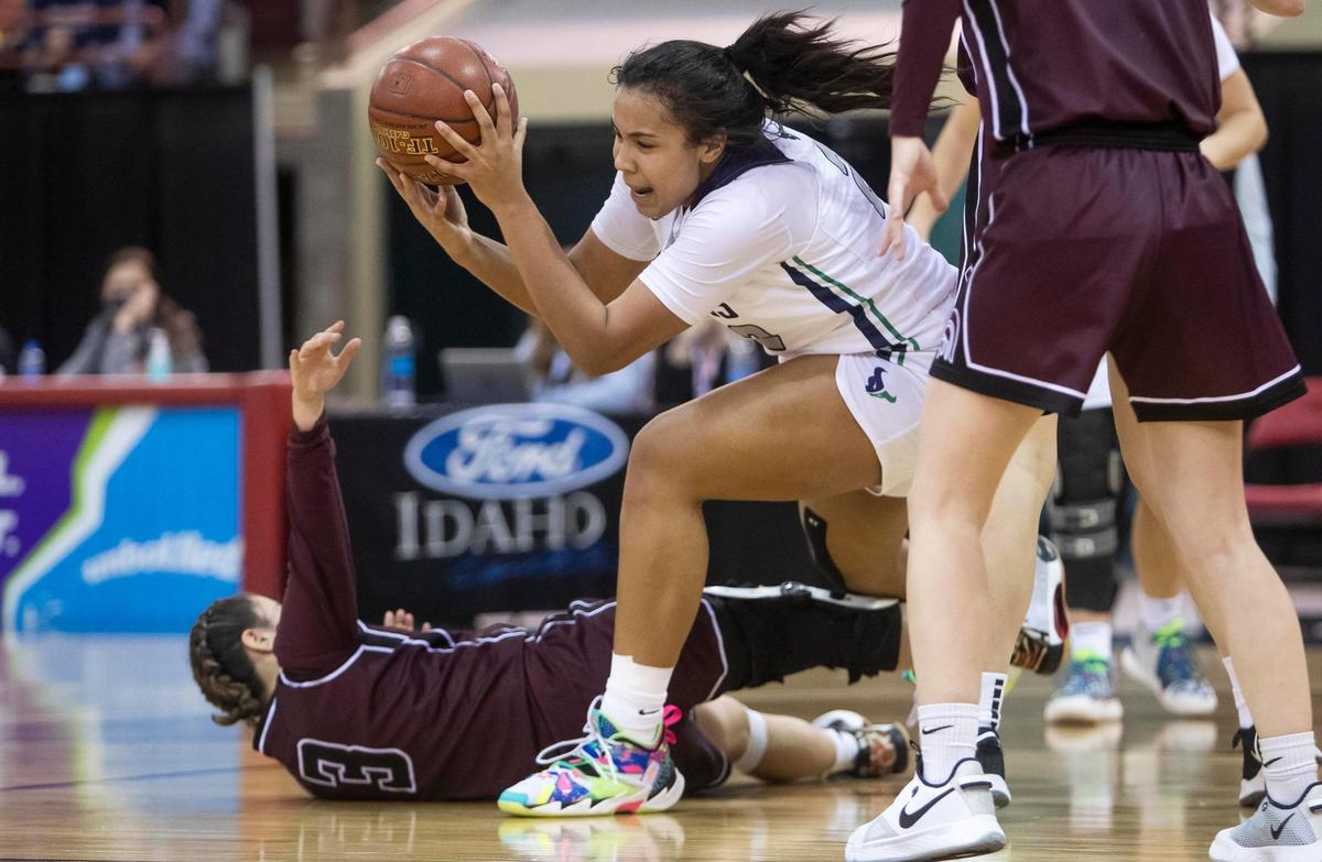 Mountain View Naya Ojukwu fights for an offensive rebound with Rigby’s Naomi Nunez on Friday at the Idaho Center.