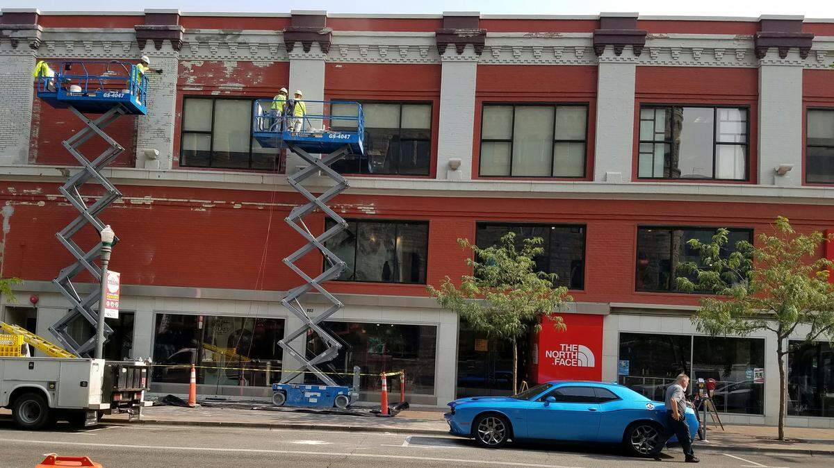 Crews work on the outside of The Mode building, which includes The North Face store, on Thursday in Downtown Boise. A real estate flier erroneously said the space used by the outdoor gear and clothing supplier was available when The North Face is only vacating the second floor of its store.