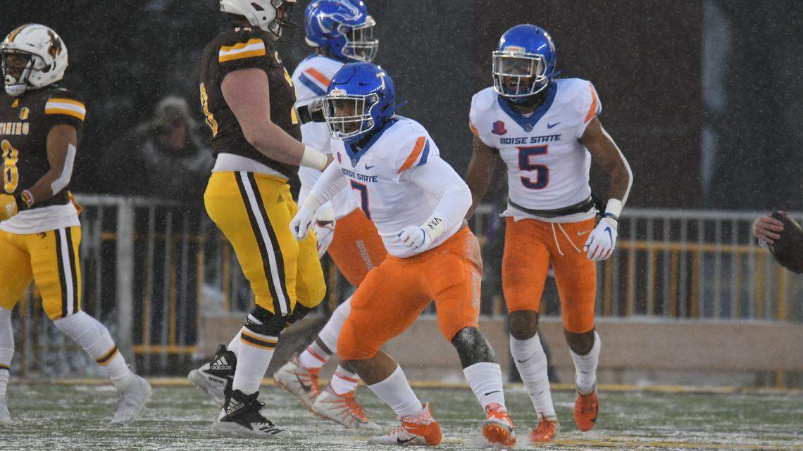 Linebacker Ezekiel Noa, center, celebrates a defensive stop during Boise State’s 17-9 win over Wyoming during a steady snowfall in Laramie in 2020. The skies should be clear when the Broncos return to War Memorial Stadium on Saturday to face the Cowboys, but temperatures could be as low as 14 degrees.