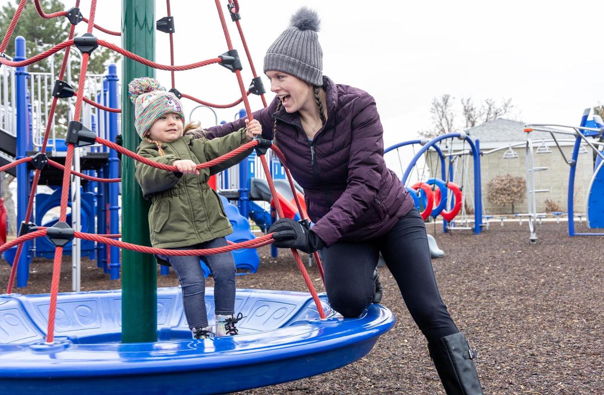 Rebecca Vincen-Brown helps her daughter Winter, 2, on the playground at Bernie Fisher Park in Kuna, Nov. 30, 2023. Vincent-Brown was one of four women who sued Idaho after they were forced to travel out of Idaho for abortion procedures.