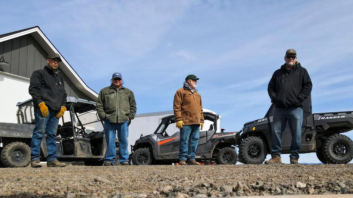 From left, Ryan Haskins, Larry Limberg, Peter Staples and Neal Vavra stand in front of their four-wheel-drive vehicles in Vavra’s front yard.