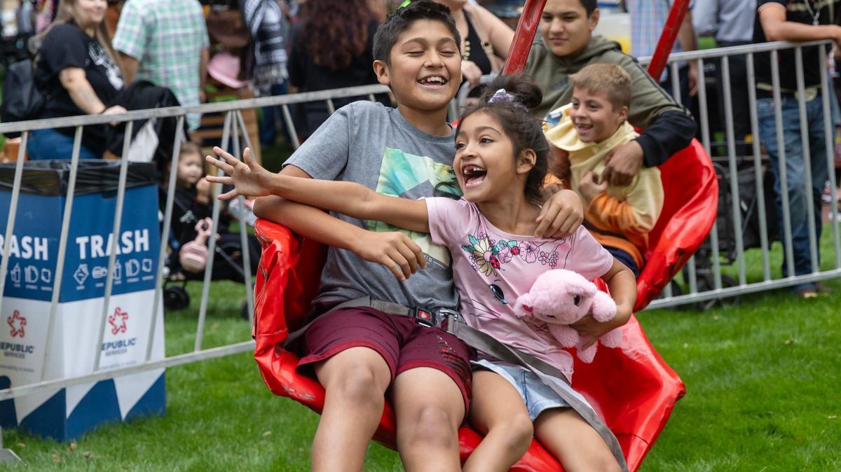 Siblings Matias Mendoza, 12, and Sofia Mendoza, 7, enjoy a ride at Latino Fest in at Cecil Andrus Park downtown Boise on Saturday.