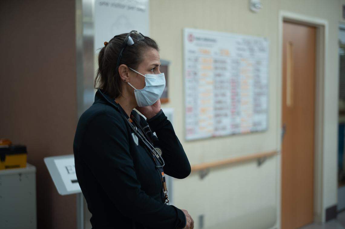 Dr. Meghan McInerney, a pulmonologist and intensivist, who also is the director of the ICU at Saint Alphonsus Regional Medical Center, stands in front of “the Board,” which is full of names of patients with COVID-19.