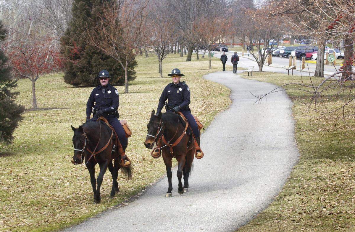 Officers Mike Riley and Dan Barber of the Boise Police Mounted Patrol ride their horses along the Boise Greenbelt in Julia Davis Park on Feb. 24, 2001.