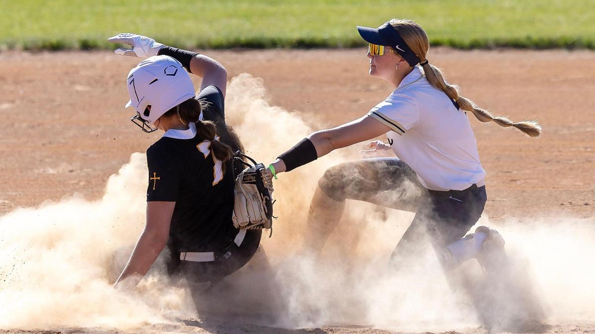 Bishop Kelly’s Lauren Fettic slides in safely before the tag from Middleton second baseman Sadie Stafford in the 5A District Three championship Thursday at Skyview.
