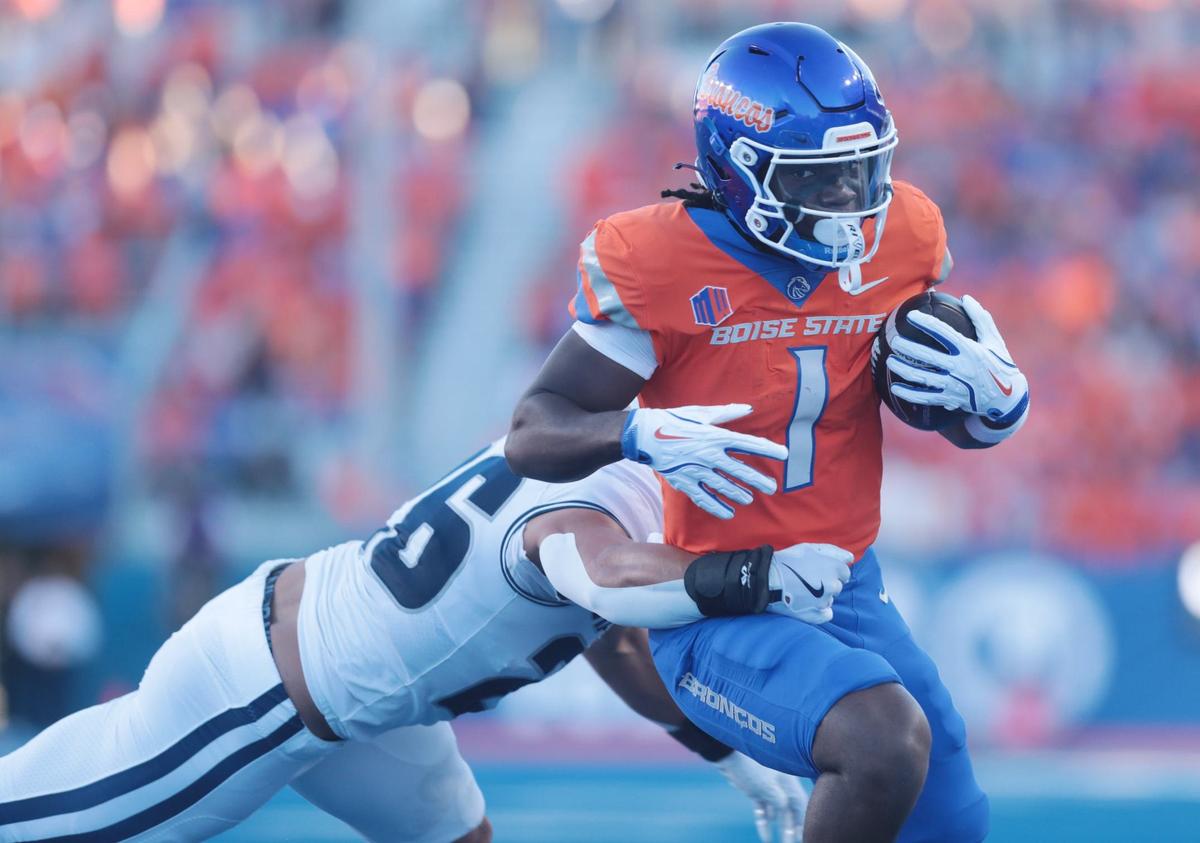Boise State running back Jambres Dubar fights off a tackle by Utah State linebacker John Miller. Boise State defeated Utah State 62-30 at Albertson’s Stadium in Boise, Idaho.