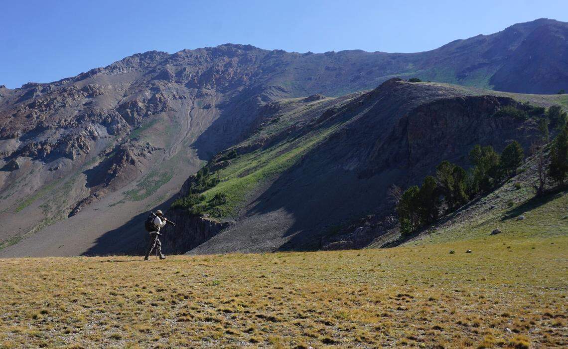 Ryan Peak, the highest mountain in the Boulder Range, juts up behind Tim Tower as he hikes the West Pass trail in the Sawtooth National Recreation Area in 2016.