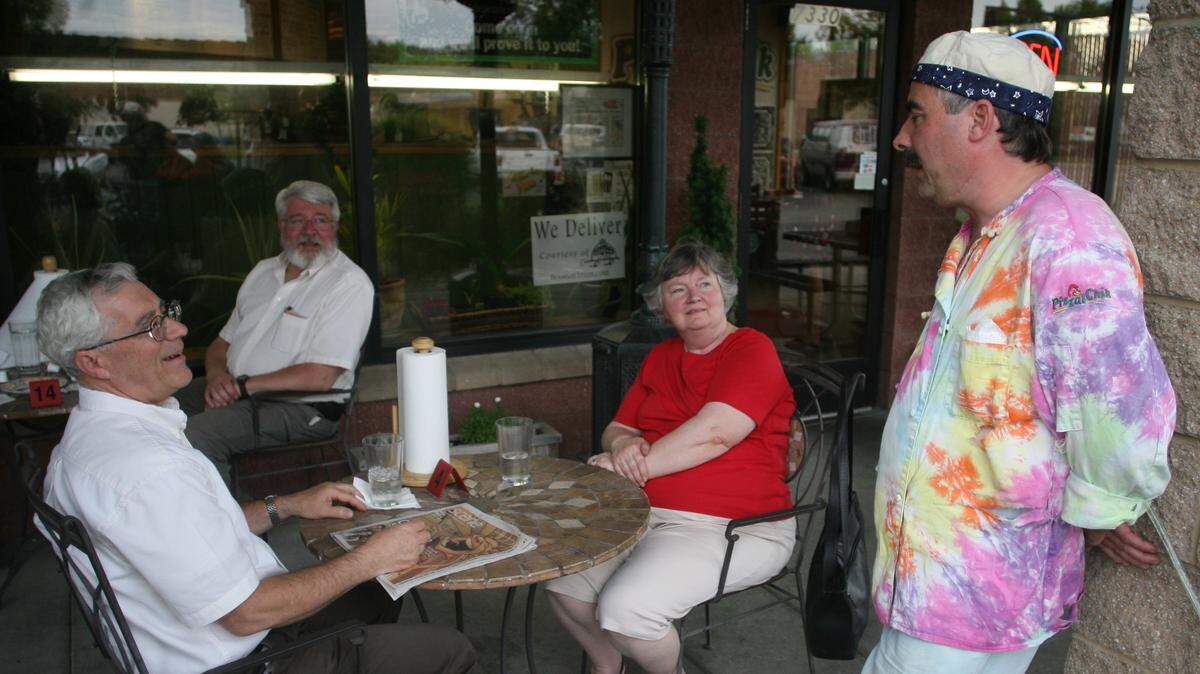 Brad Breakell talks with customers on the patio at PizzalChik in 2008.
