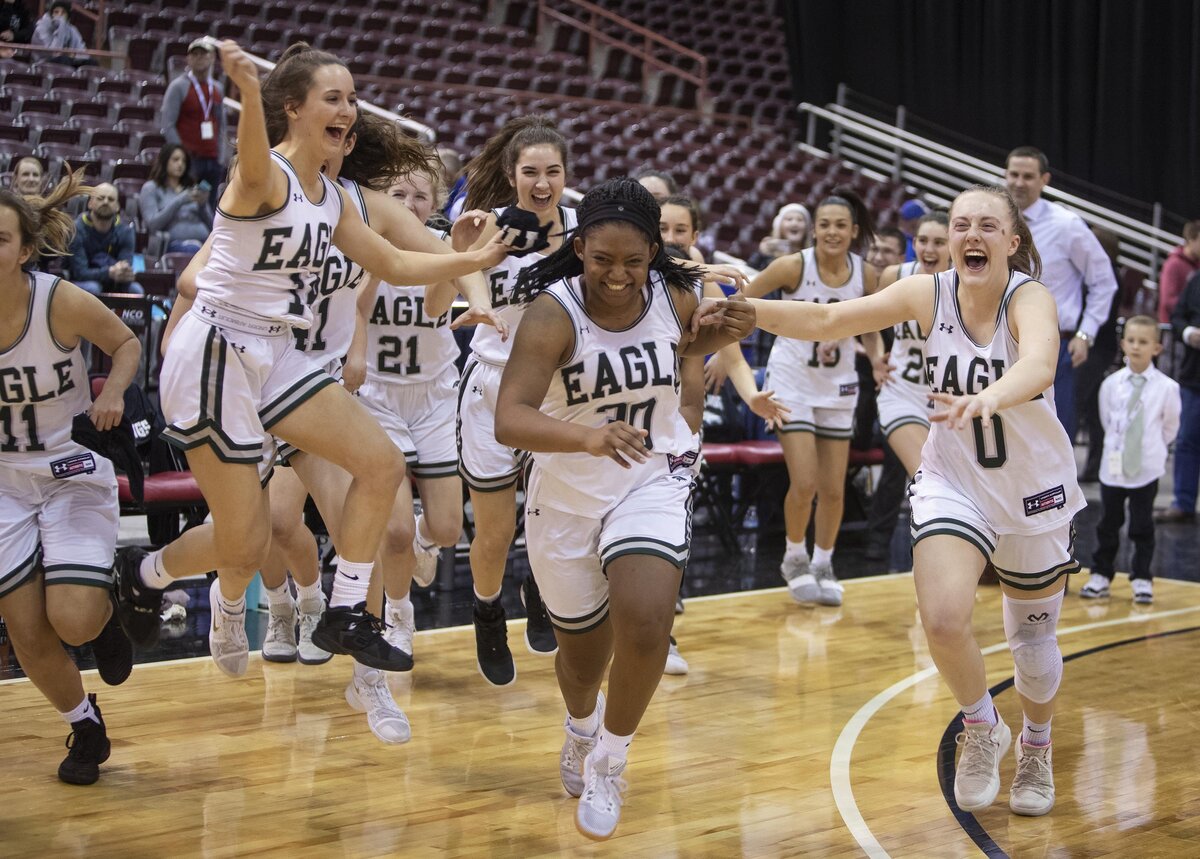 Eagle’s girls basketball team runs to receive the state 5A girls basketball championship trophy after defeating Mountain View 51-47 Saturday, Feb. 16, 2019 at Ford Idaho Center in Nampa.